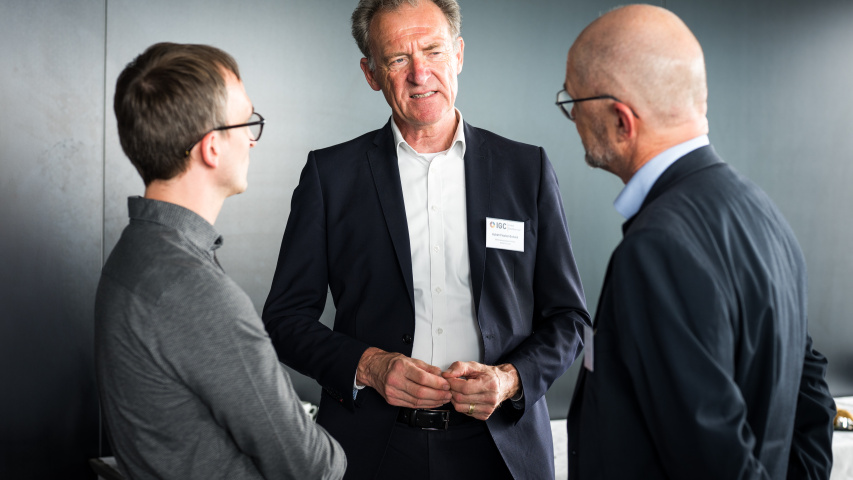 Drei Männer unterhalten sich.